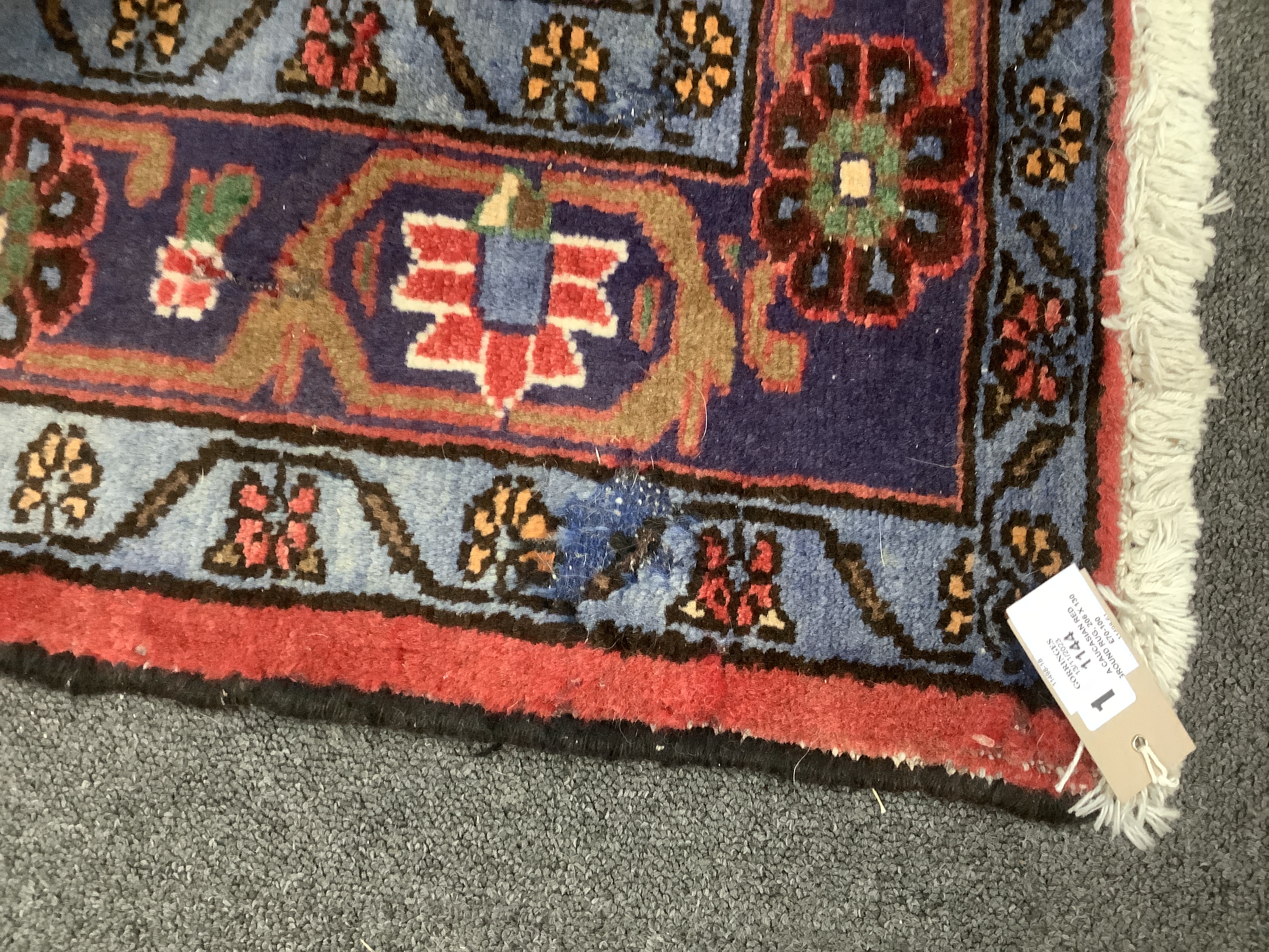 A Caucasian red ground rug, 206 x 130cm